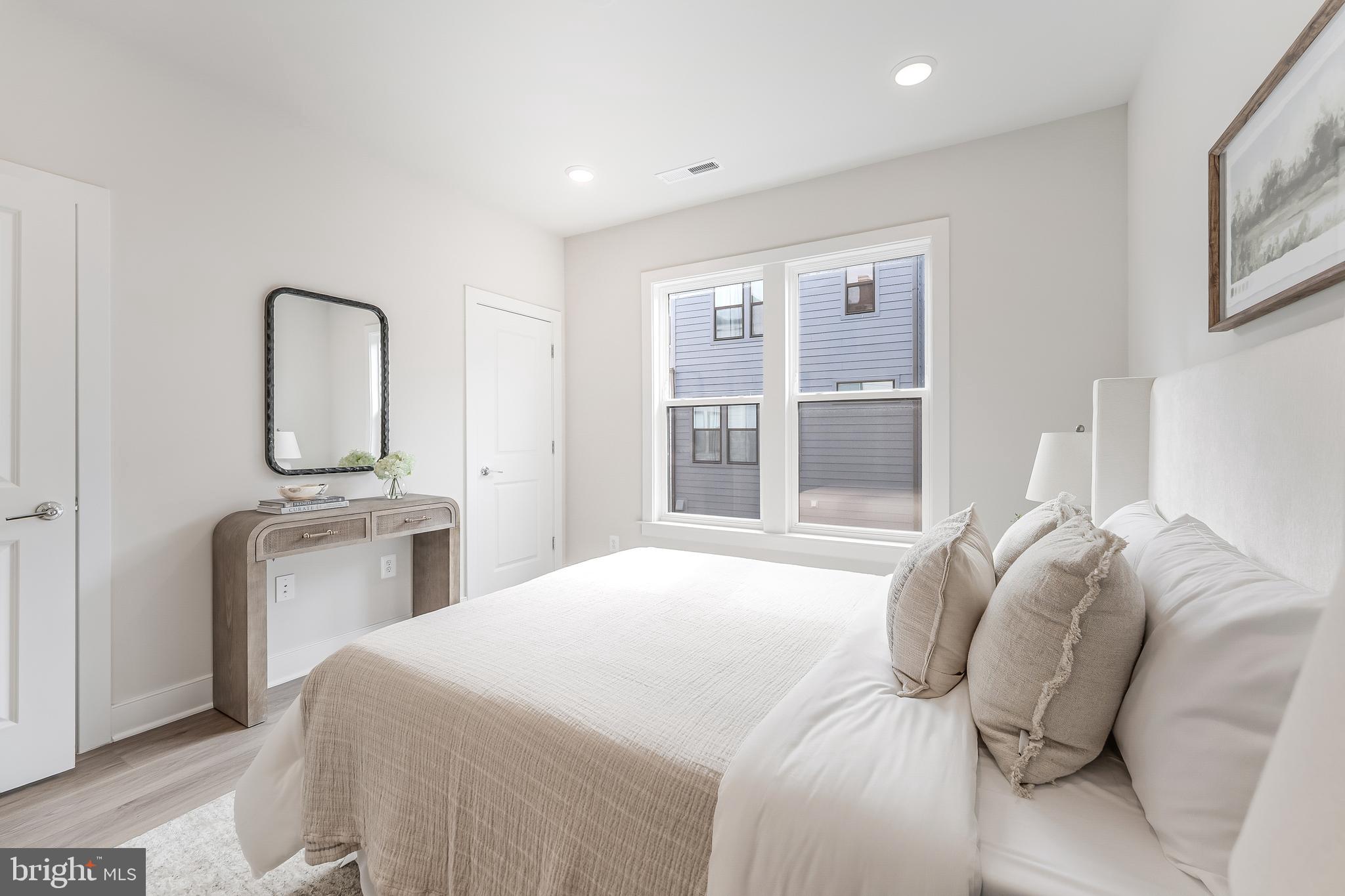 12742 Verdant Way Reston, VA 20191 - Photo 27 of 51 a bedroom with a bed and a large mirror on the dresser