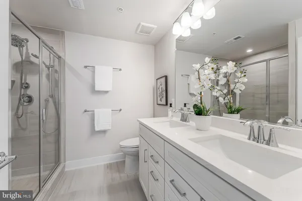 a bathroom with a shower a toilet and a sink