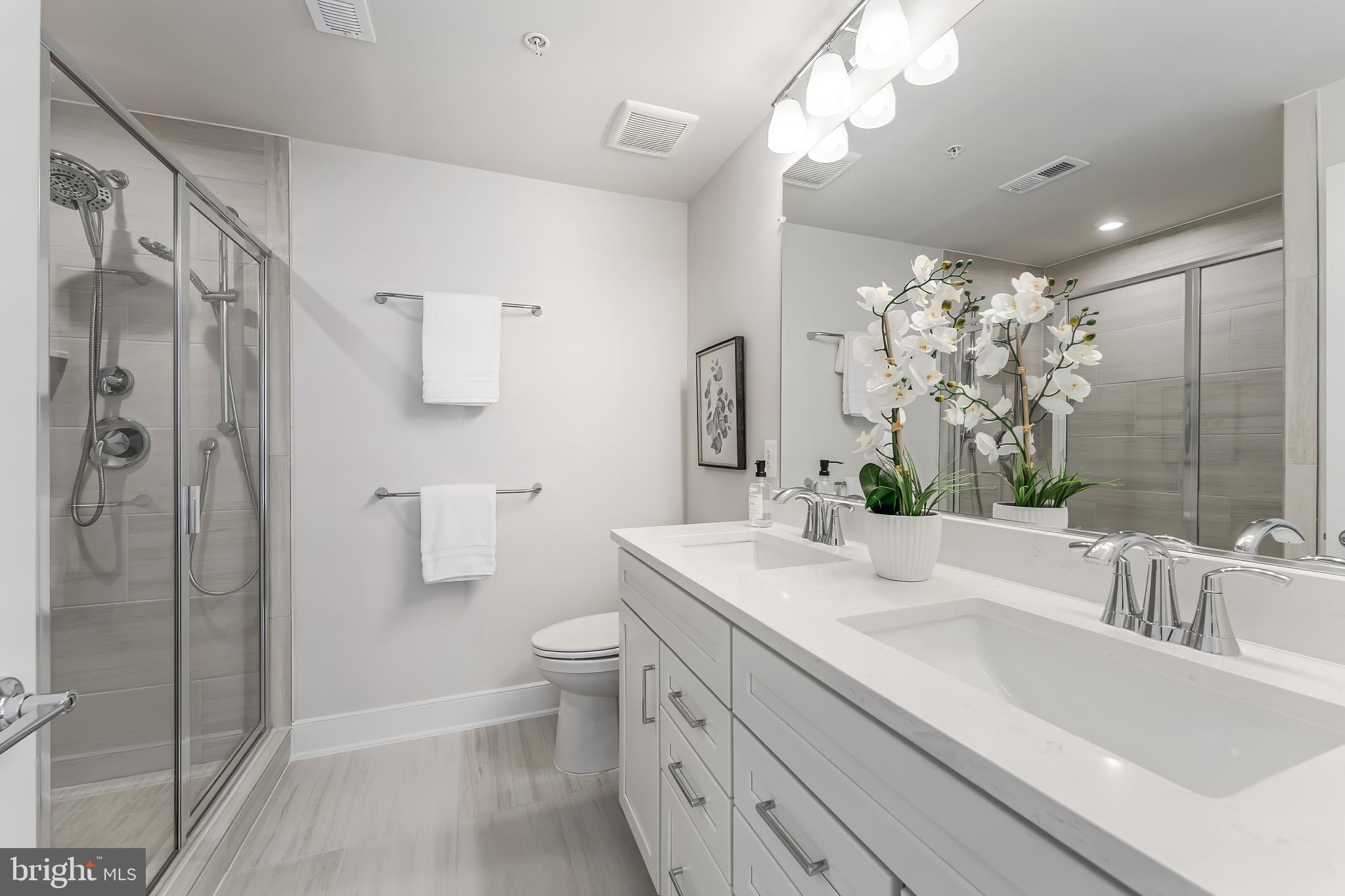 12742 Verdant Way Reston, VA 20191 - Photo 28 of 51 a bathroom with a sink a toilet and shower