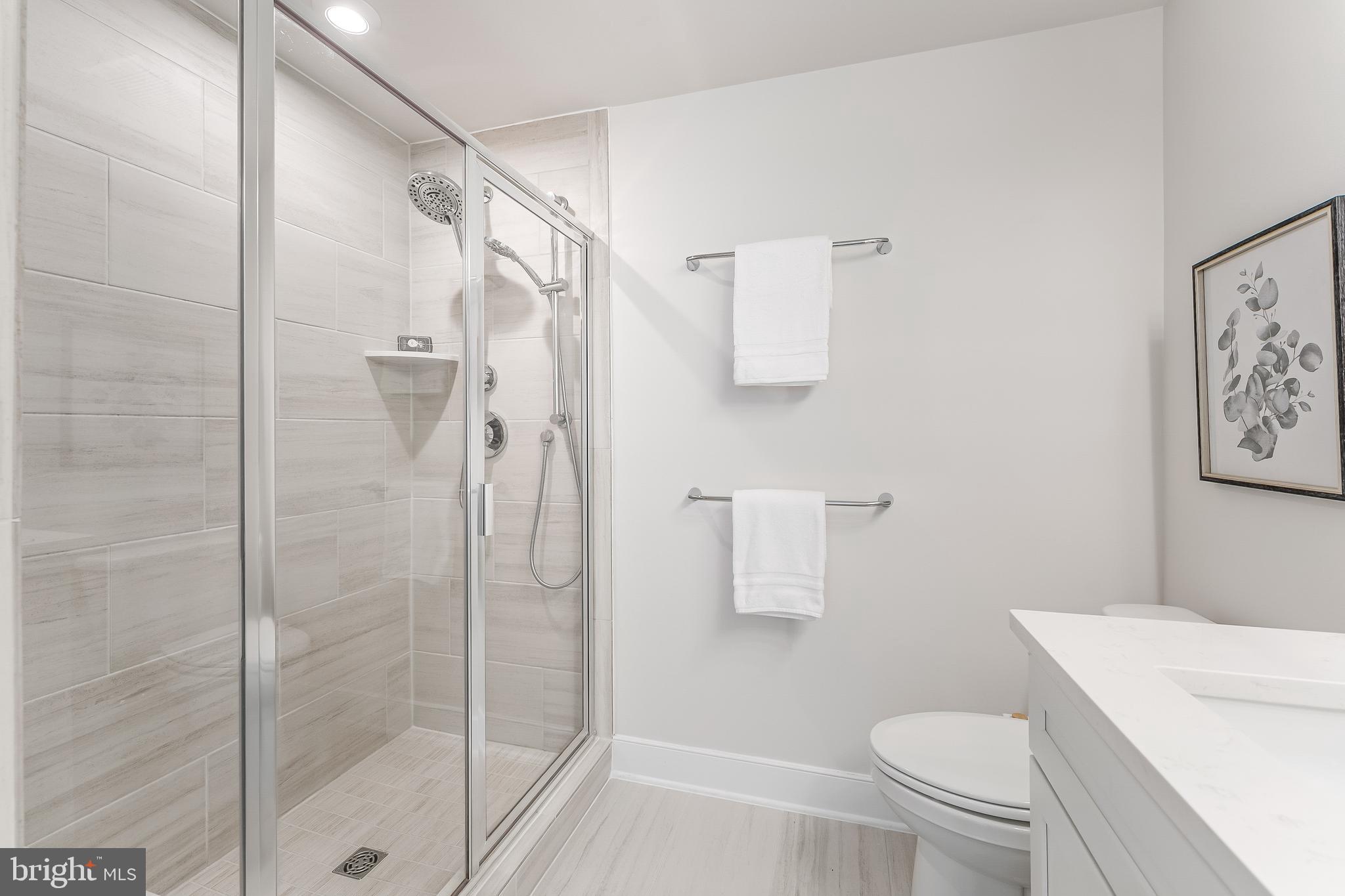 12742 Verdant Way Reston, VA 20191 - Photo 29 of 51 a bathroom with a shower a toilet and a sink