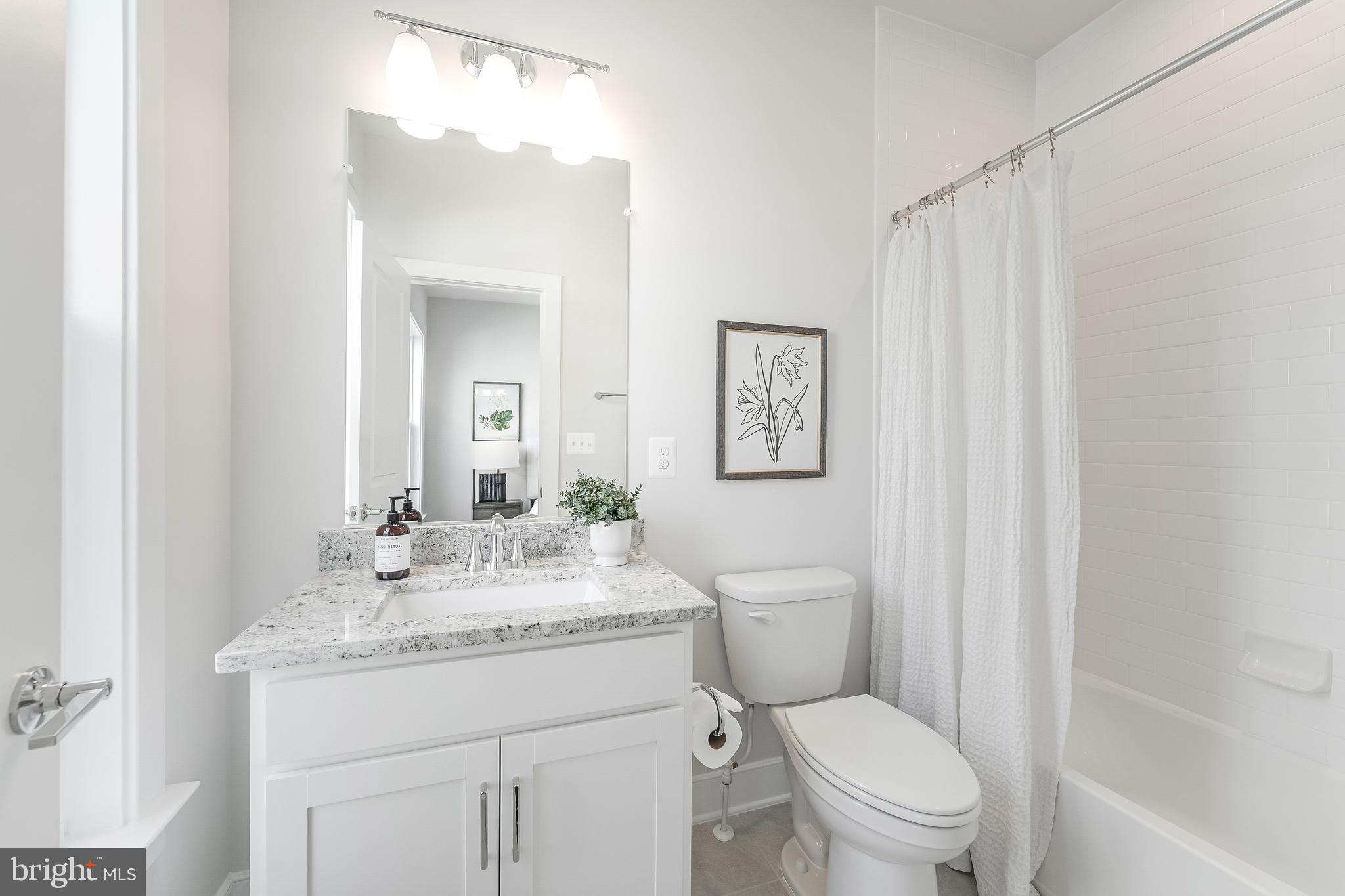 12742 Verdant Way Reston, VA 20191 - Photo 34 of 51 a bathroom with a granite countertop toilet sink and mirror