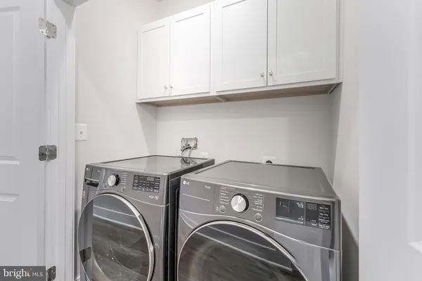a room with kitchen island a sink and a refrigerator