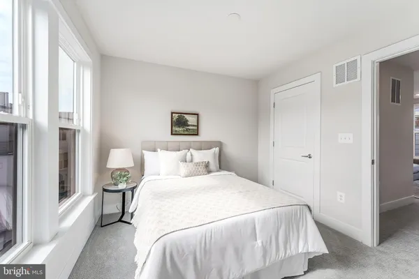 a bedroom with a bed and a painting on the wall