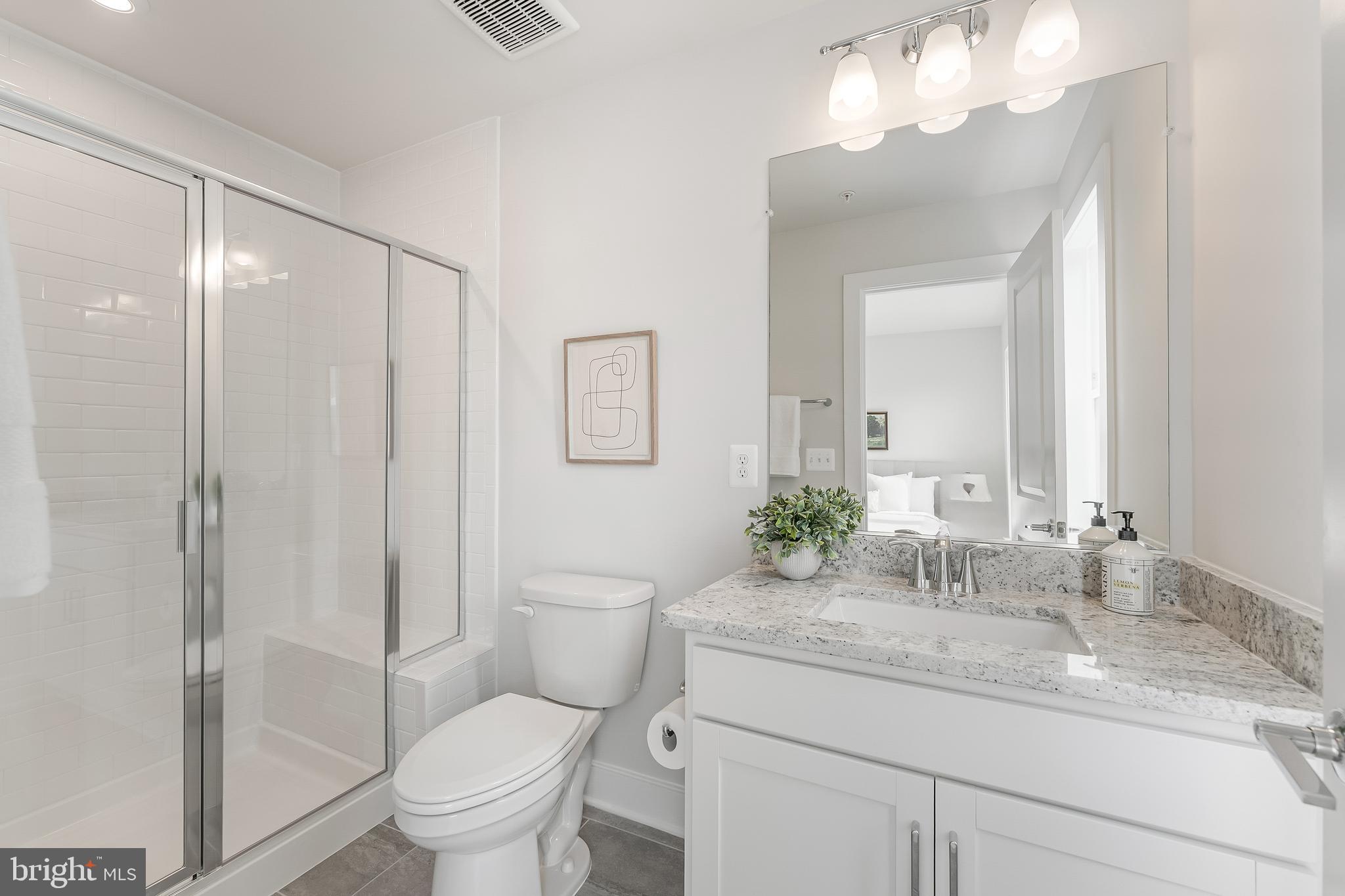 12742 Verdant Way Reston, VA 20191 - Photo 42 of 51 a bathroom with a granite countertop sink a toilet and a mirror