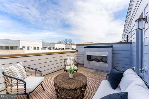 a balcony with furniture and a fireplace