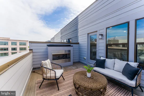 a balcony with furniture and wooden floor