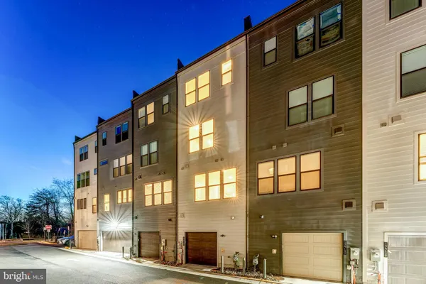 a kitchen with stainless steel appliances granite countertop a refrigerator a oven a sink a stove and white cabinets with wooden floor