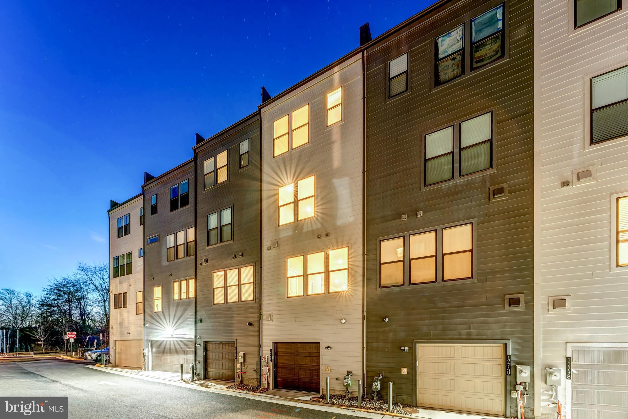 12742 Verdant Way Reston, VA 20191 - Photo 6 of 51 a front view of a building with a street