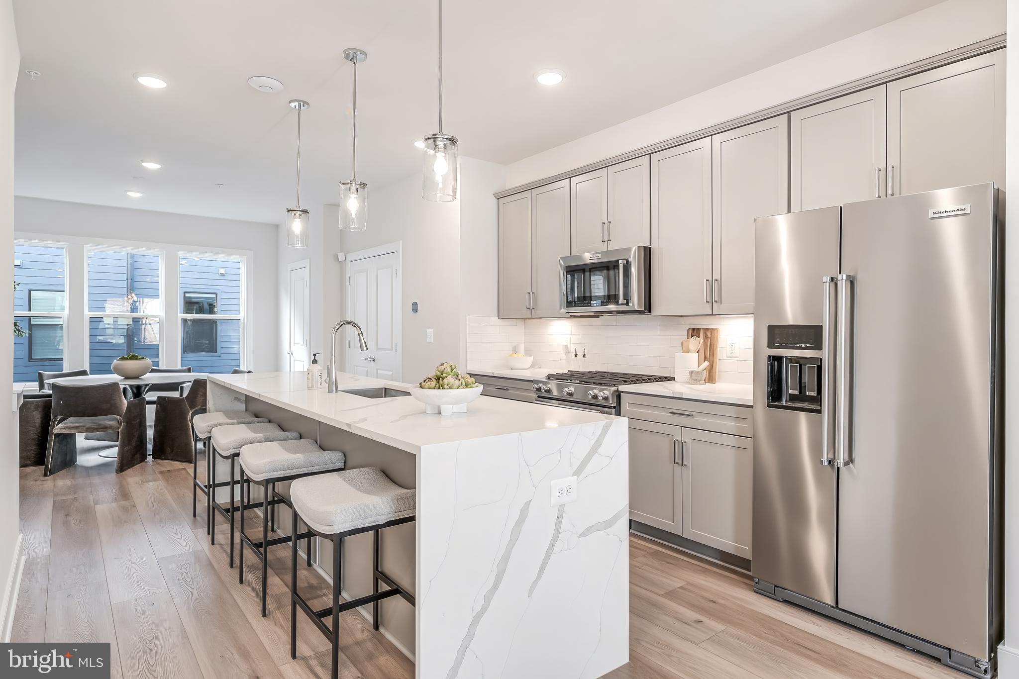 12742 Verdant Way Reston, VA 20191 - Photo 7 of 51 a kitchen with stainless steel appliances granite countertop a refrigerator a oven a sink a stove and white cabinets with wooden floor