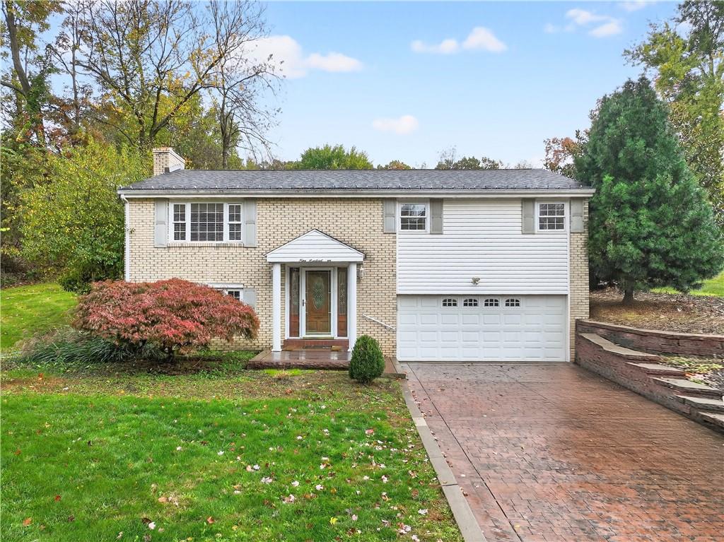 a front view of a house with a garden and plants