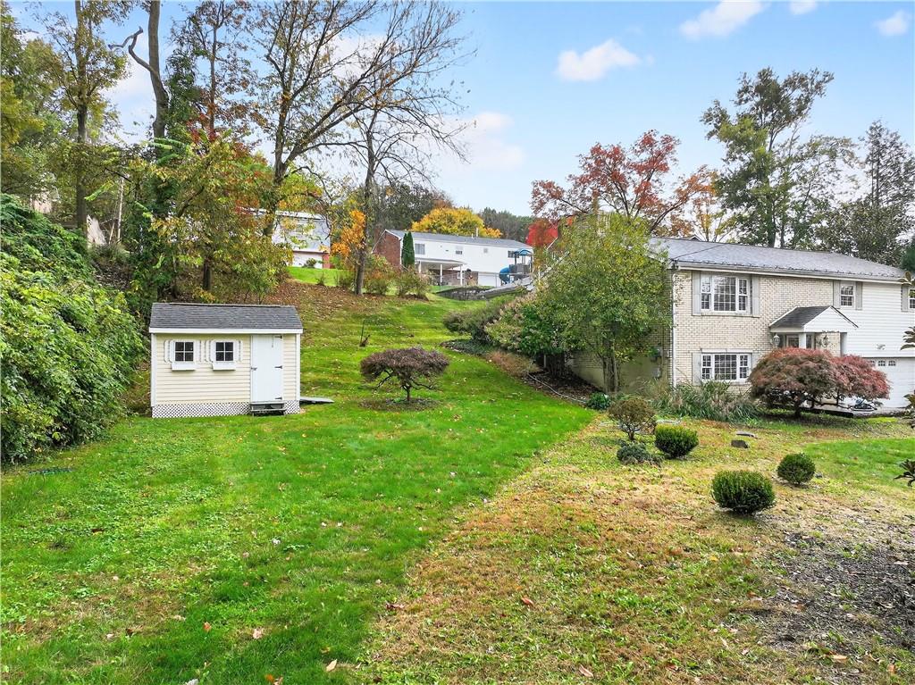 910 Burchfield Road Allison Park, PA 15101 - Photo 20 of 21 a view of an house with backyard space and garden