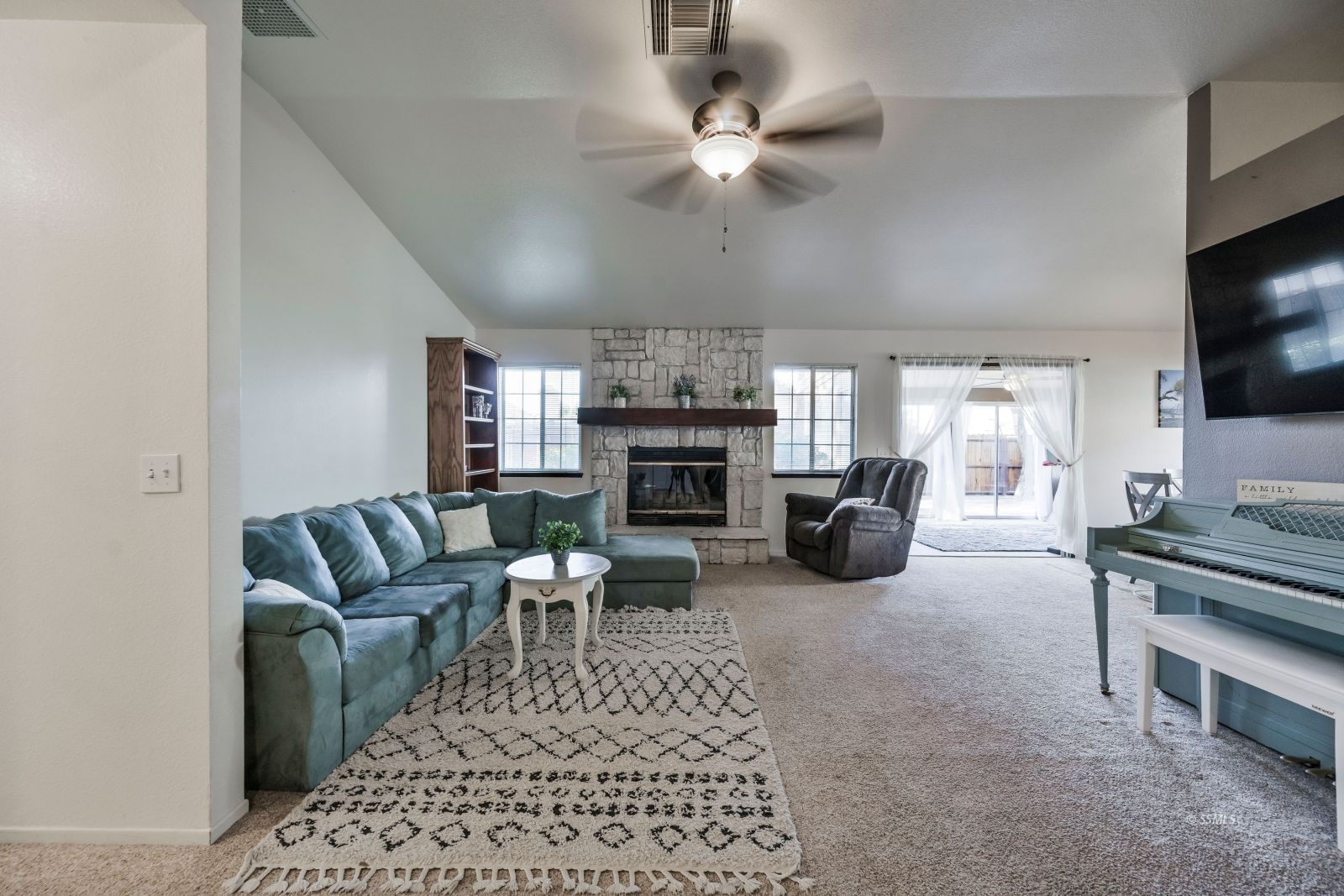 404 Veada Avenue Ridgecrest, CA 93555 - Photo 7 of 33 a living room with furniture a flat screen tv and a fireplace