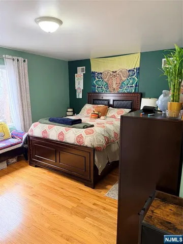 a bed sitting in a bedroom next to a window