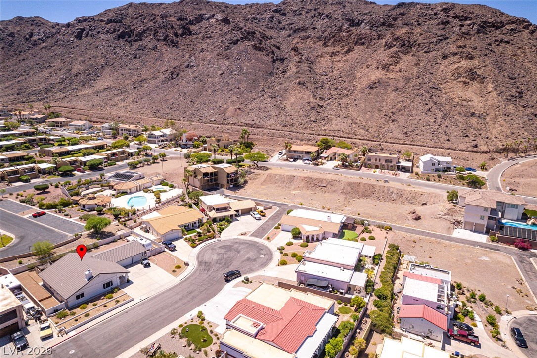 524 Swallow Cove Boulder City, NV 89005 - Photo 52 of 58 An aerial perspective reveals a vibrant neighborhood nestled against a majestic mountain backdrop.