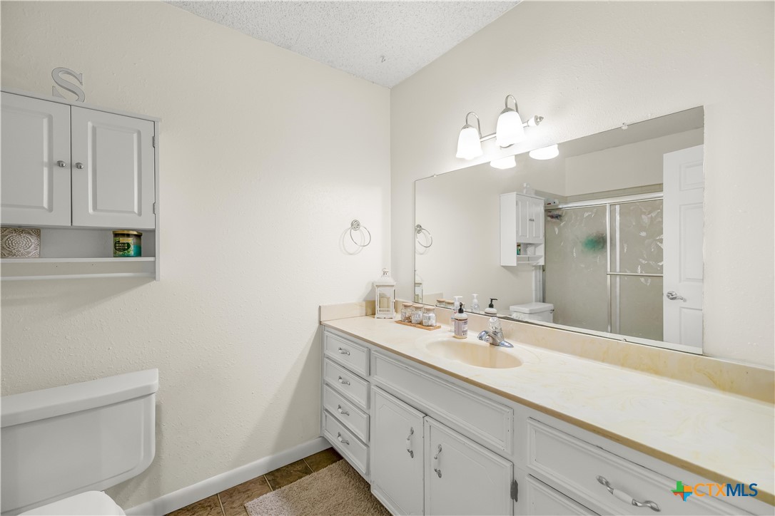 307 Pheasant Drive Victoria, TX 77905 - Photo 14 of 33 a bathroom with a sink a large mirror and vanity