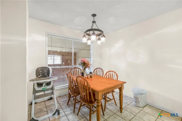 a view of a dining room with furniture and window