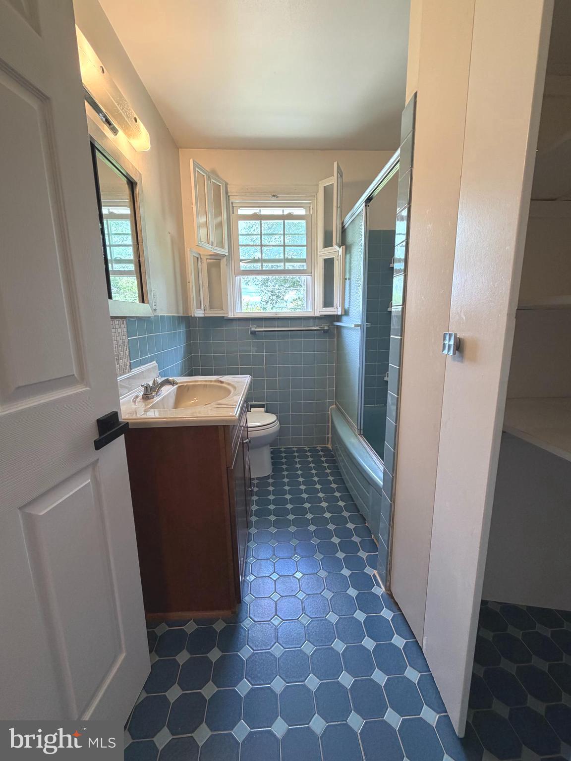 1207 Greenhill Road Flourtown, PA 19031 - Photo 7 of 9 a utility room with a sink a toilet a window and vanity