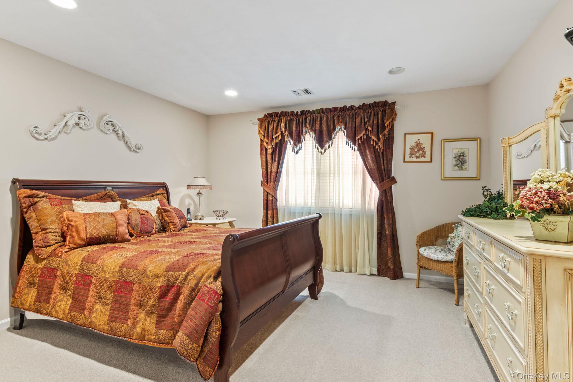 77 The Woods Commack, NY 11725 - Photo 21 of 31 Bedroom with light colored carpet and recessed lighting