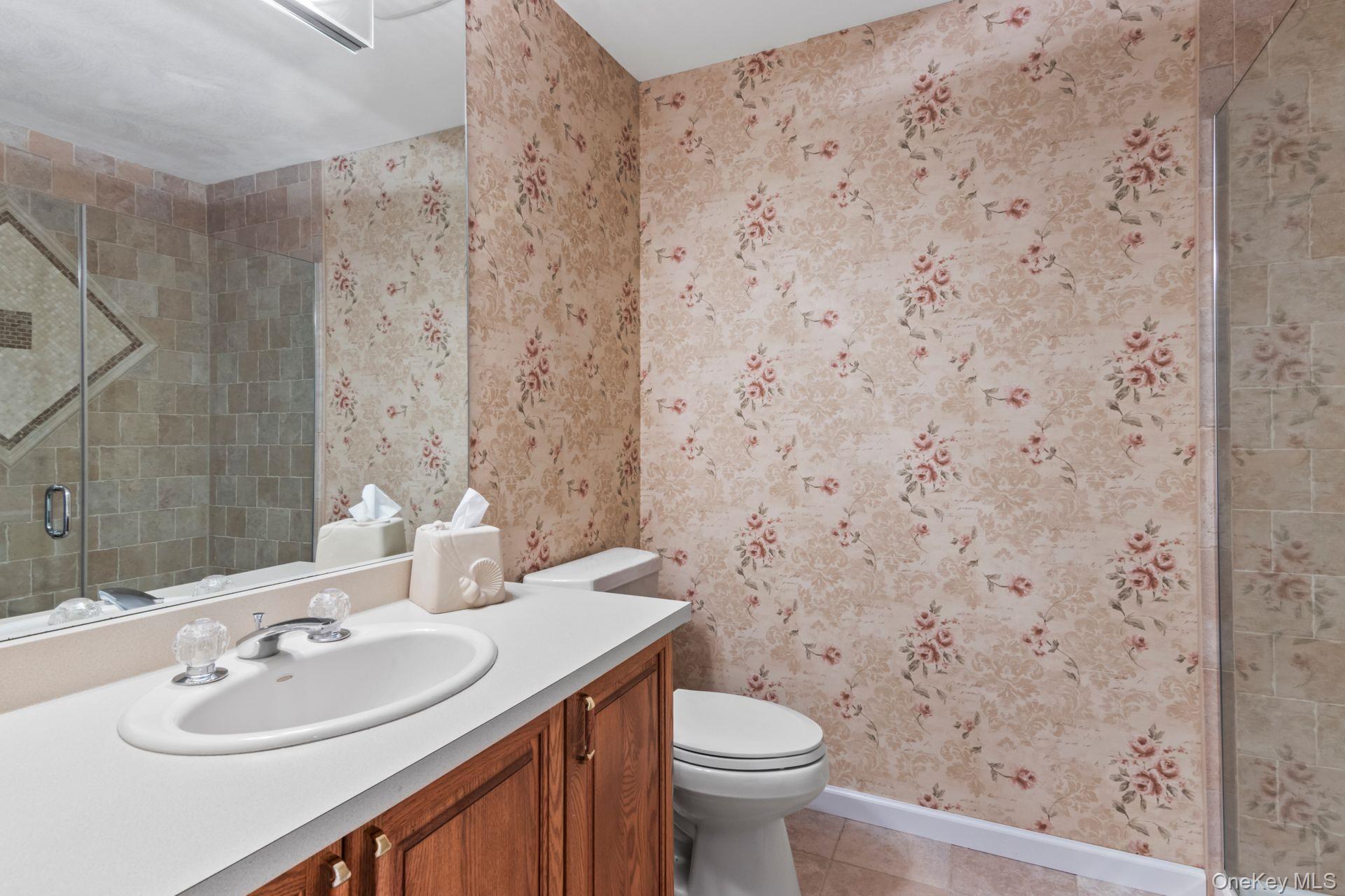 77 The Woods Commack, NY 11725 - Photo 22 of 31 Bathroom with a shower stall, wallpapered walls, vanity, and light tile patterned floors