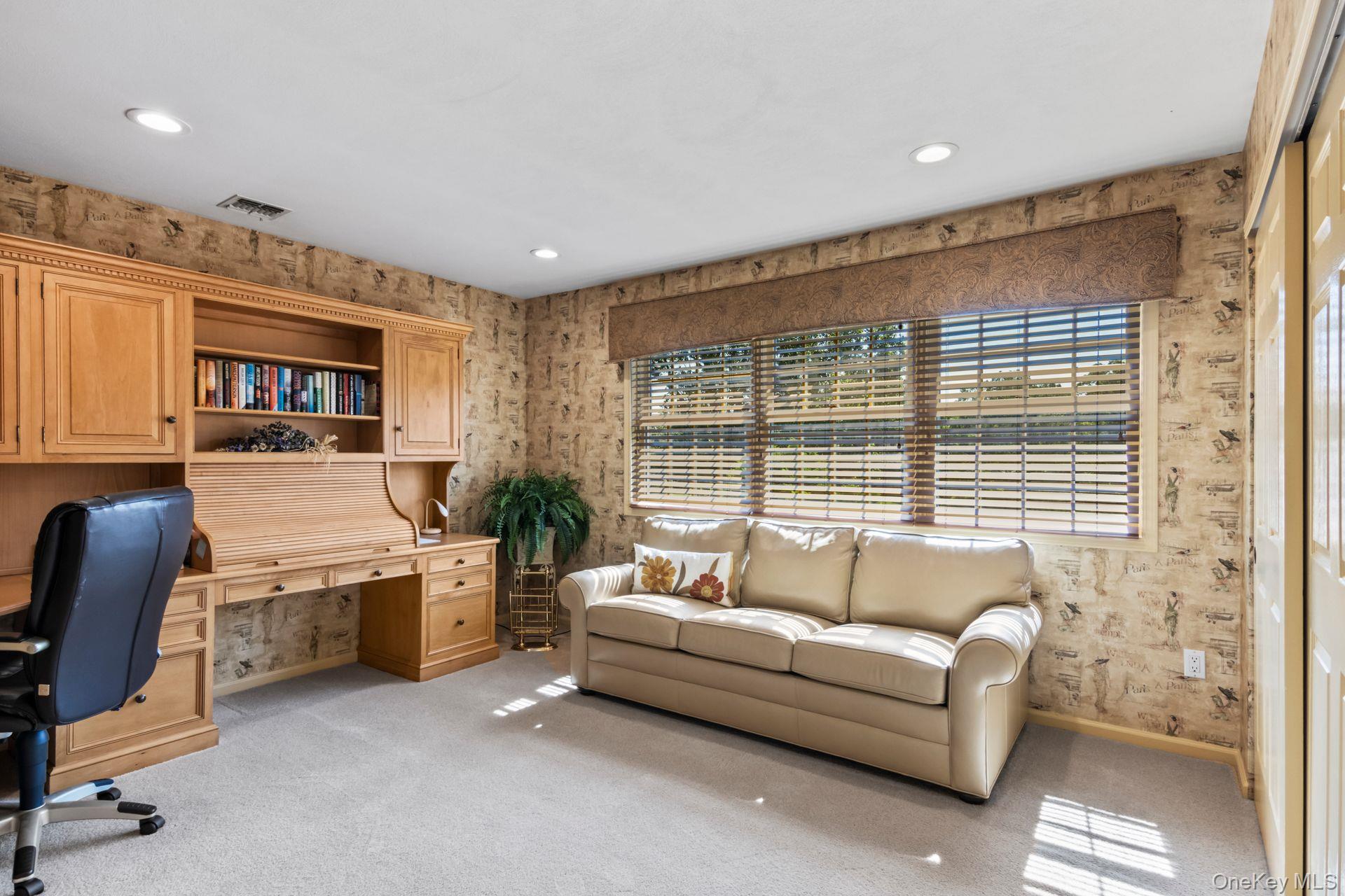 77 The Woods Commack, NY 11725 - Photo 23 of 31 Home office with light colored carpet and wallpapered walls