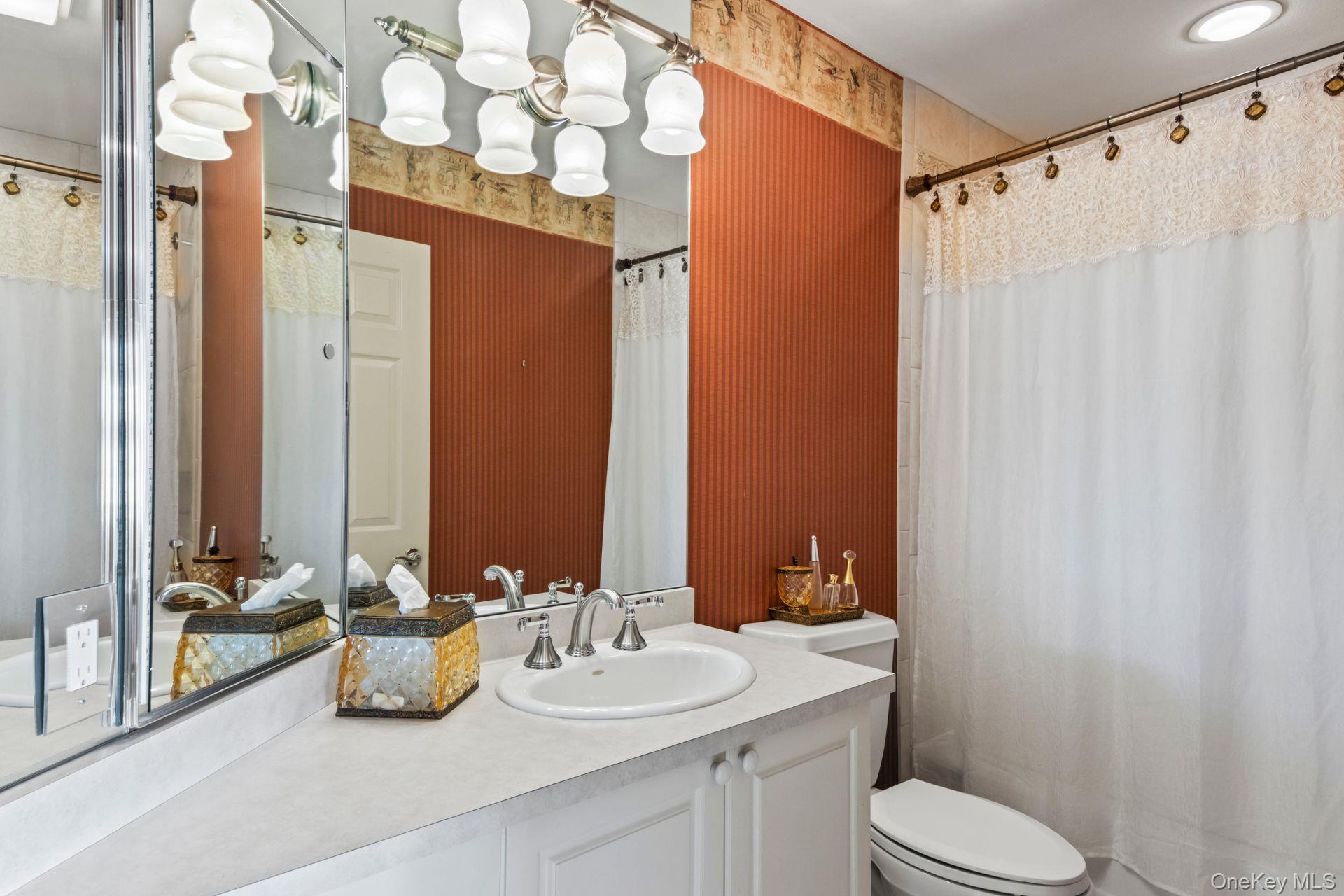 77 The Woods Commack, NY 11725 - Photo 24 of 31 Bathroom featuring wallpapered walls, vanity, and a shower with shower curtain