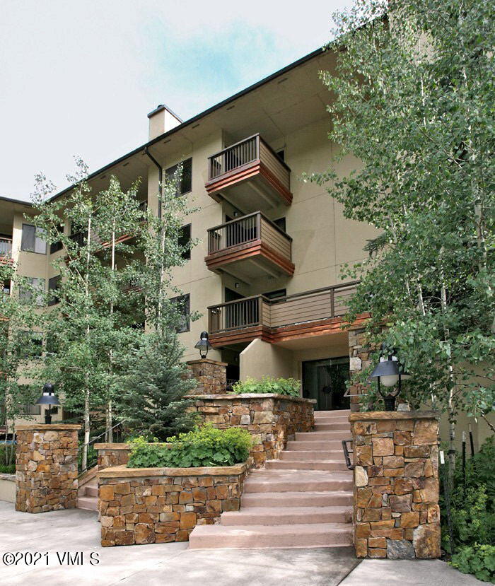 1650 Fall Ridge Road, Unit 113 Vail, CO 81657 - Photo 2 of 4 a front view of a house with a yard