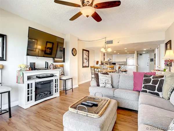 a living room with furniture and a large window with wooden floor