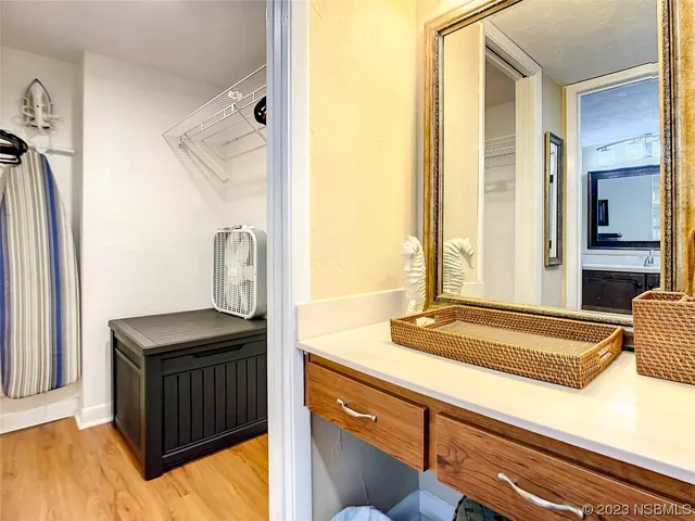 a bedroom with a bed a rug and a large window