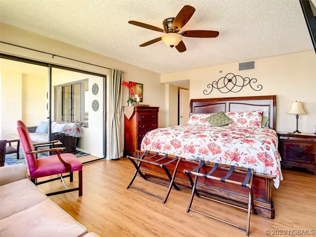 a bedroom with a bed a couch and a window