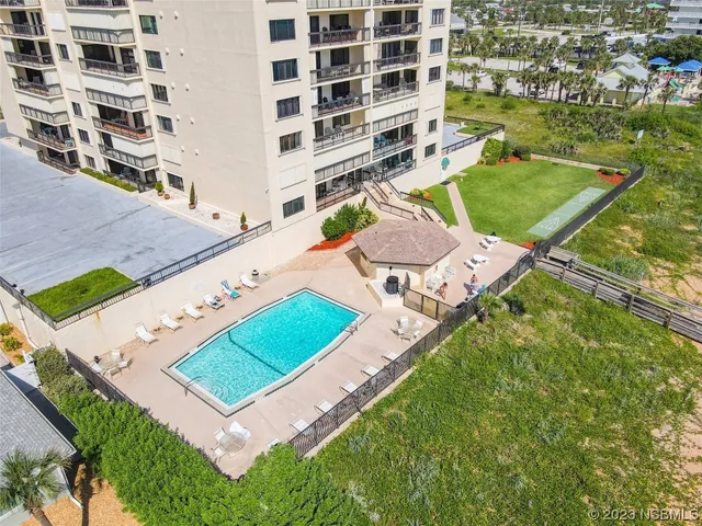 an aerial view of a residential house with a yard