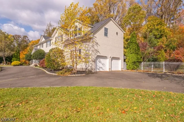 a view of a house with a yard and garage