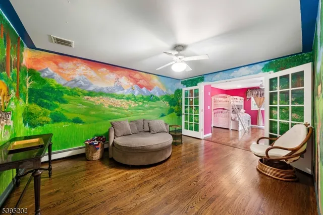 a living room with patio furniture and a garden