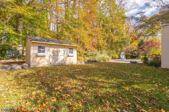 a view of a house with a yard and garage