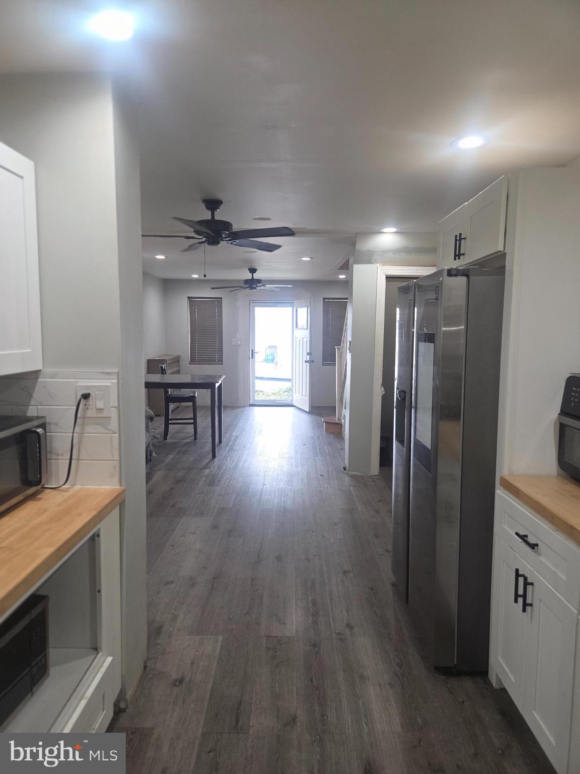 6378 Marsden Street Philadelphia, PA 19135 - Photo 16 of 24 a view of a kitchen with a sink a refrigerator a fireplace and wooden floor