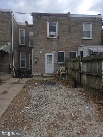 a backyard of a house with barbeque oven