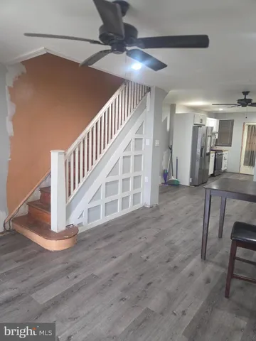 a view of entryway and hall with wooden floor