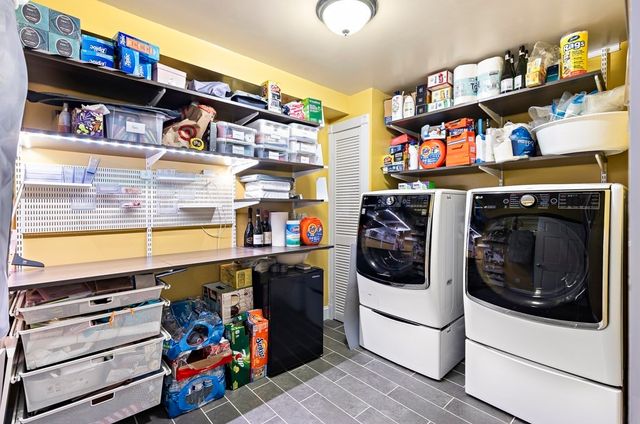 a storage utility room with washer and dryer