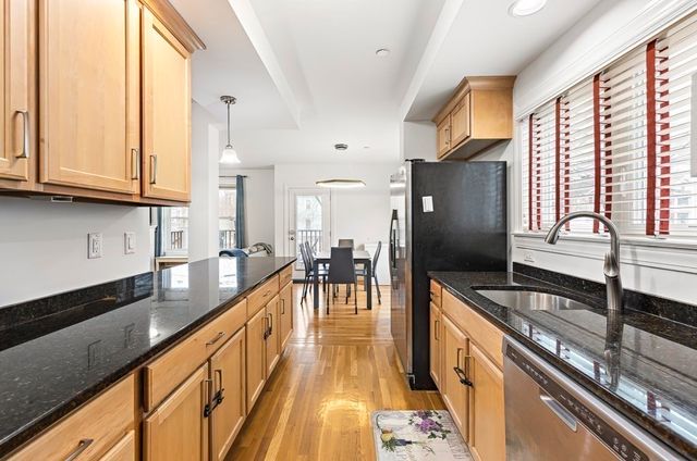 a kitchen with stainless steel appliances granite countertop a stove a sink and a refrigerator