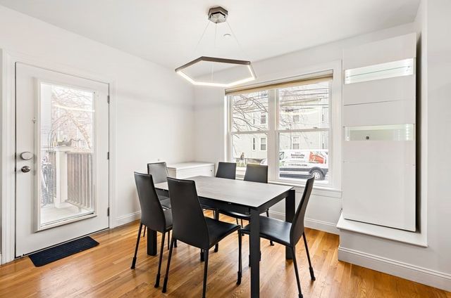 a view of a dining room with furniture window and wooden floor