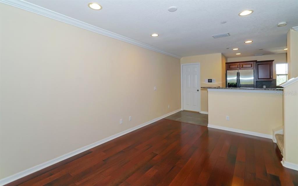 7339 Black Walnut Way Lakewood Ranch, FL 34202 - Photo 5 of 27 a view of a kitchen with a sink and wooden floor