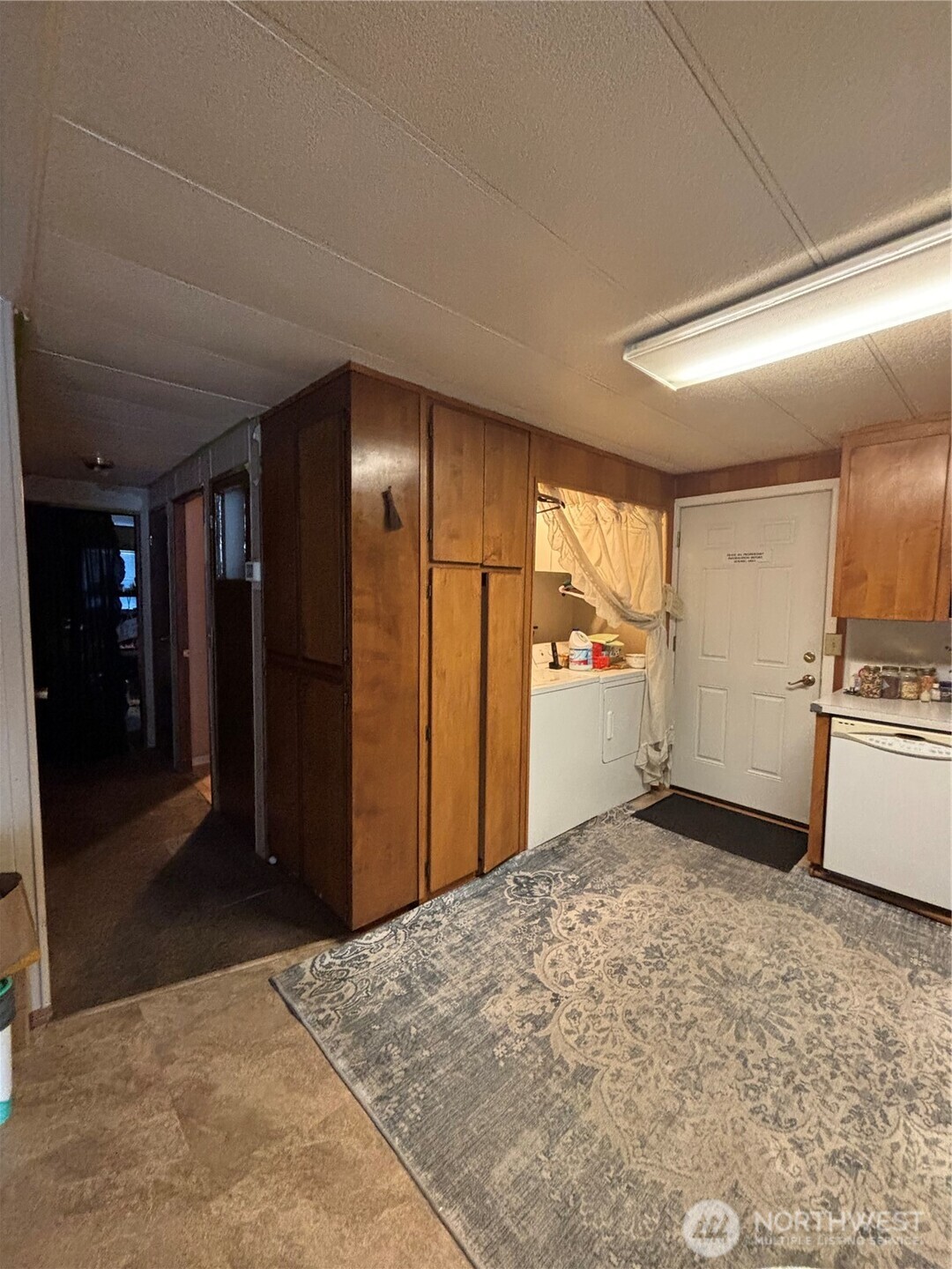 1841 Trosper Road Southwest, Unit 60 Tumwater, WA 98512 - Photo 9 of 18 a view of a refrigerator in kitchen and an empty room