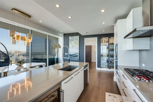 a kitchen with stainless steel appliances granite countertop a sink a stove and a refrigerator