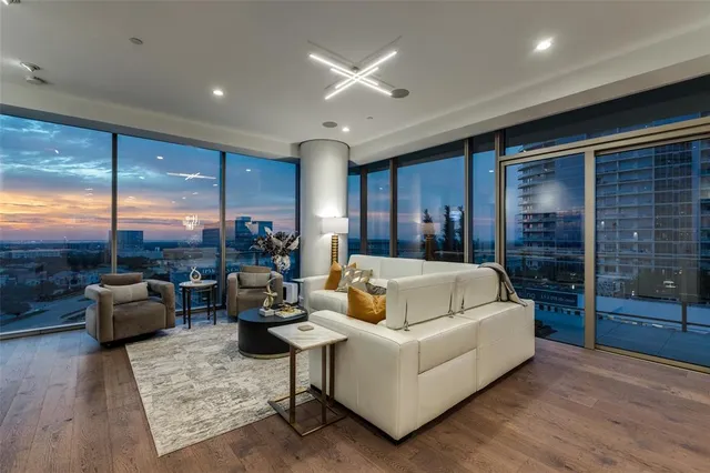 a living room with patio furniture and a large window
