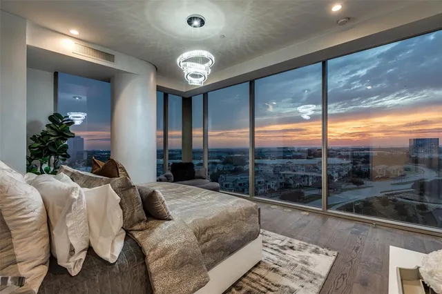 a bedroom with a large bed and a large window