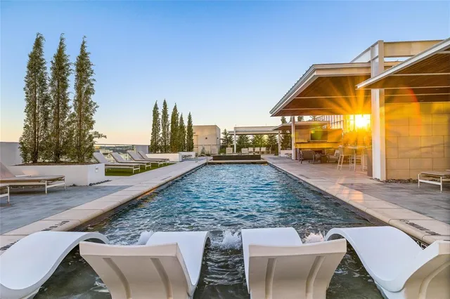 a view of a swimming pool with a lounge chairs