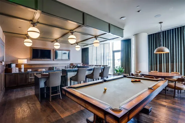 a room with furniture pool table and windows