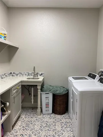 a utility room with a sink a washer and dryer