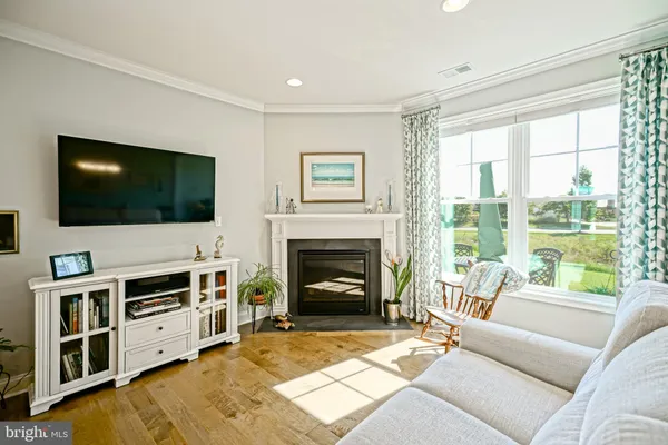 a living room with furniture fireplace and flat screen tv