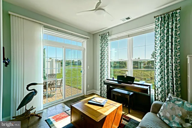 a living room with furniture wooden floor and a dining table