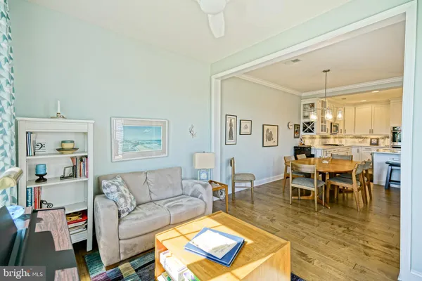 a living room with furniture a dining table and a large window